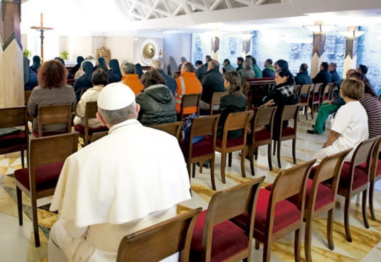 papa Francisco en una iglesia sentado en los bancos de atrás